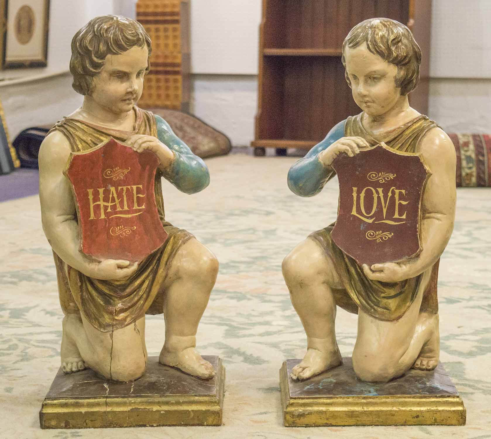 KNEELING FIGURES, a pair, 19th century polychrome and giltwood,