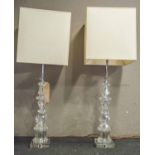 TABLE LAMPS, a pair, Baccarat manner glass, of knopped facet column form with square cream shades,