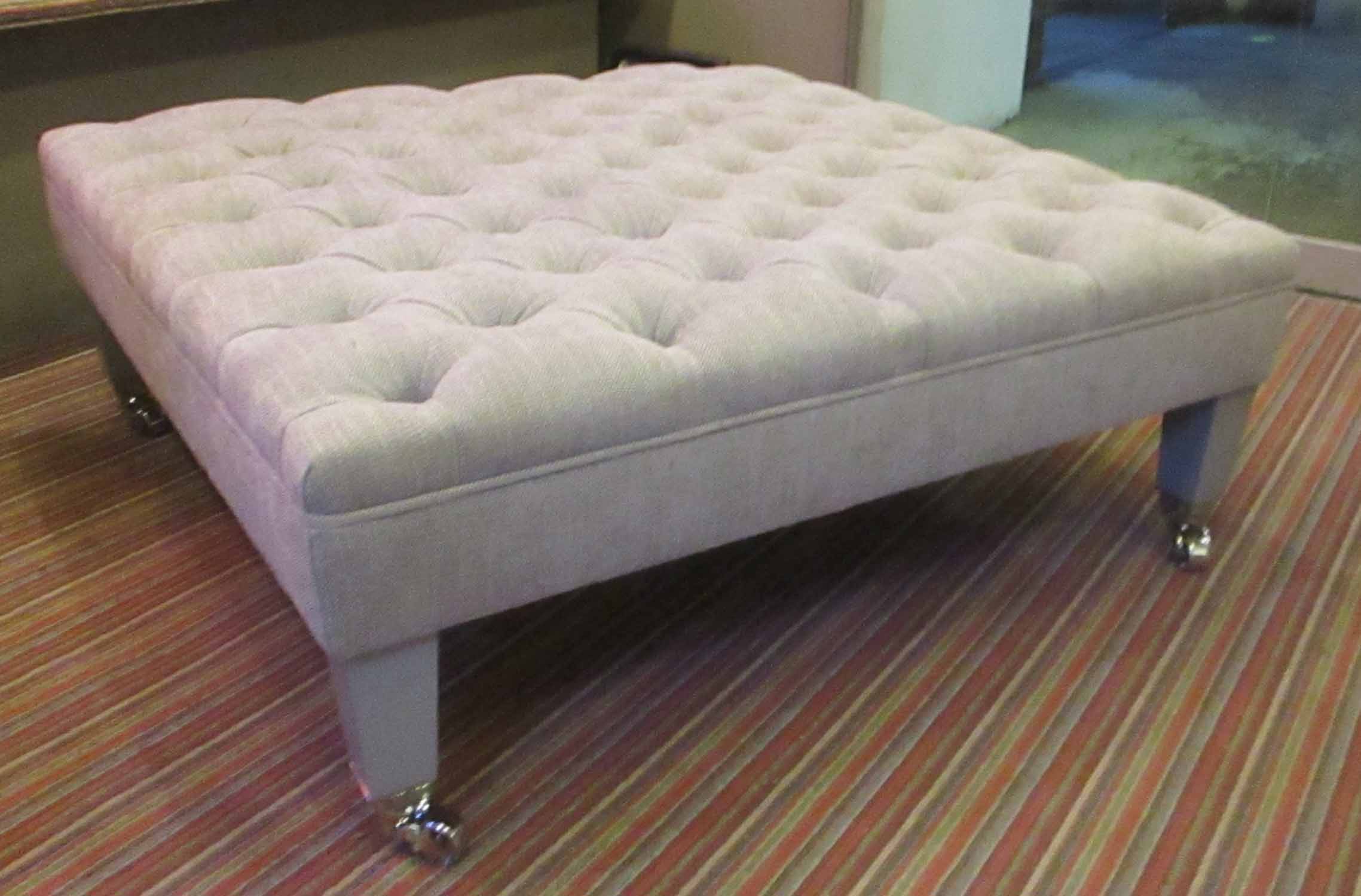 OTTOMAN EMPIRE FOOTSTOOL, square with deep buttoned grey upholstery on castors,