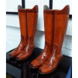 RIDING/WALKING STICK STANDS, two pairs, country estate boots design stylised finish, 48cm H x 25cm.