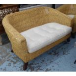 CONSERVATORY WICKER SOFA, rounded back on splayed legs, with cushion and chair to match.