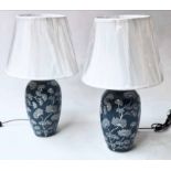 LAMPS, a pair Chinese ceramic blue and white foliate vase form with shades, 52cm H.