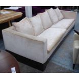 SOFA, of large proportions in a champagne coloured chenille on an exotic wood plinth,