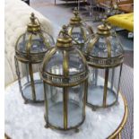 LANTERNS, a set of four, gilt metal domed tops glazed.