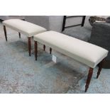 STOOLS, a pair, each with beige upholstery on reeded turned supports, 98cm L x 46cm H x 40cm D.
