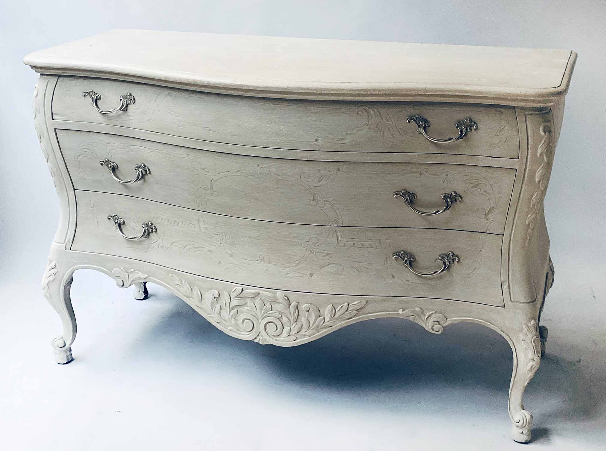 COMMODE, Italian grey painted and silvered metal, bombe form with three long drawers,