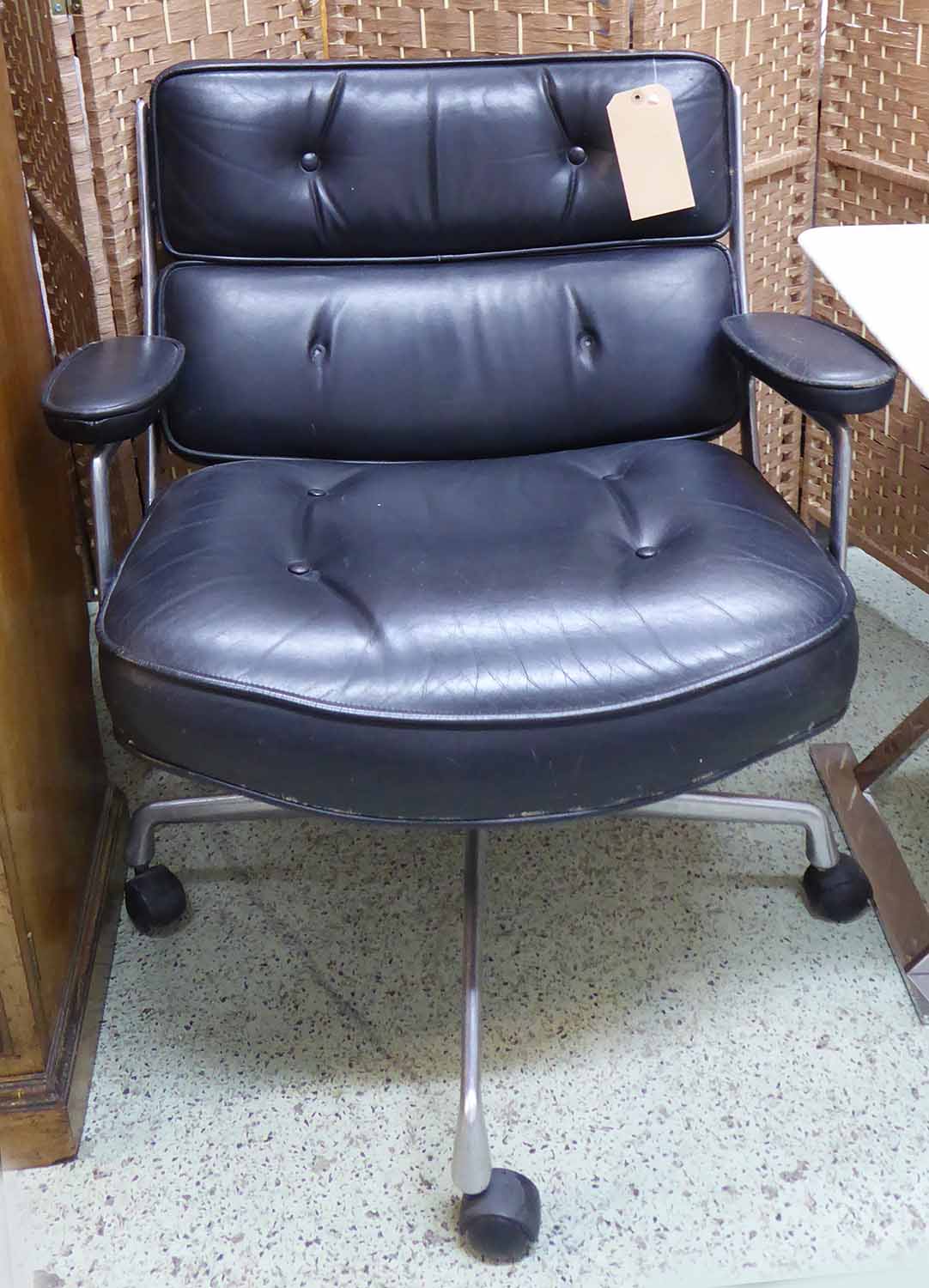 LOBBY CHAIR, Charles and Ray Eames buttoned leather, aluminium frame and swivel base on castors.