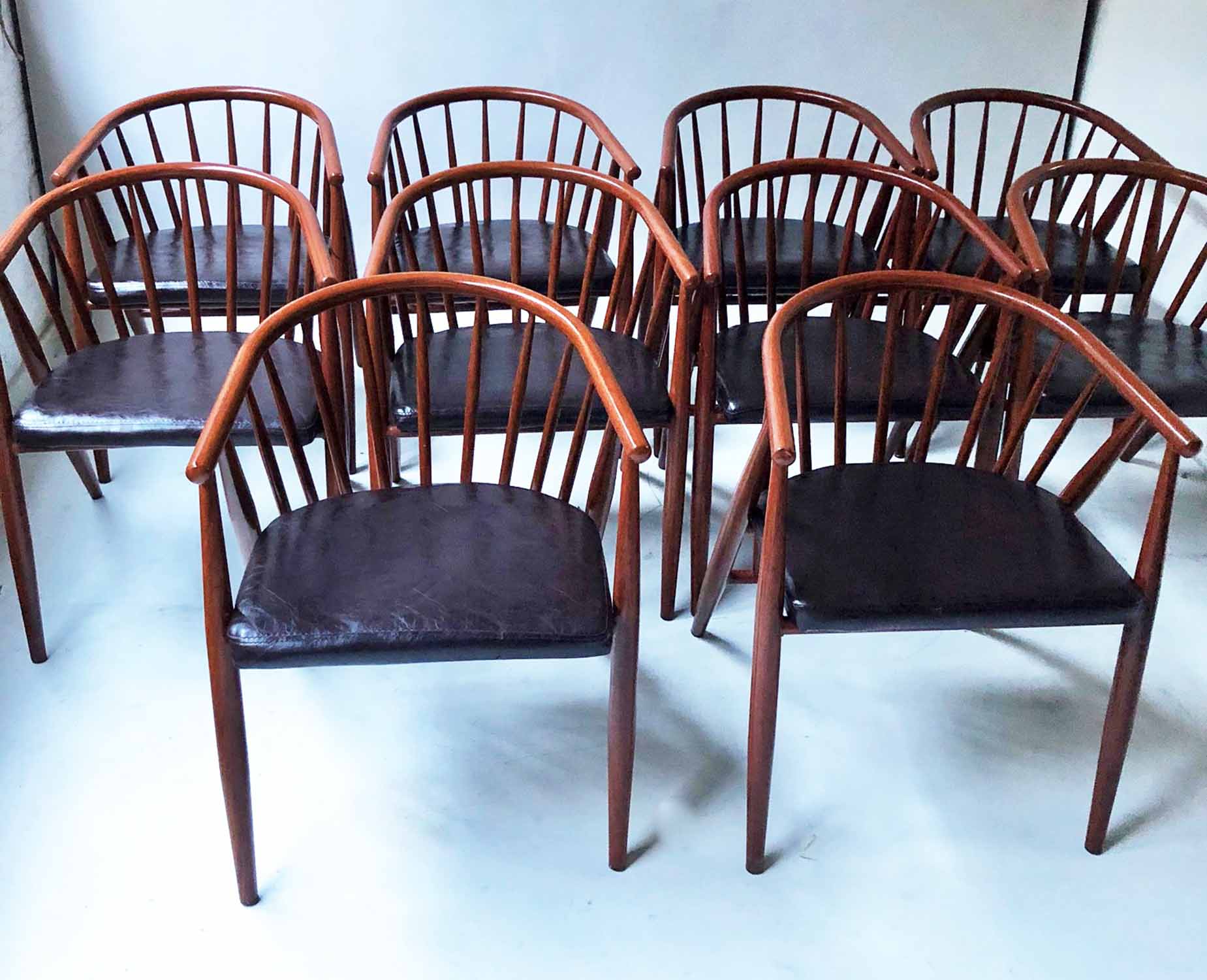 DINING ARMCHAIRS, a set of ten, metal bowed stick back in teak effect finish.