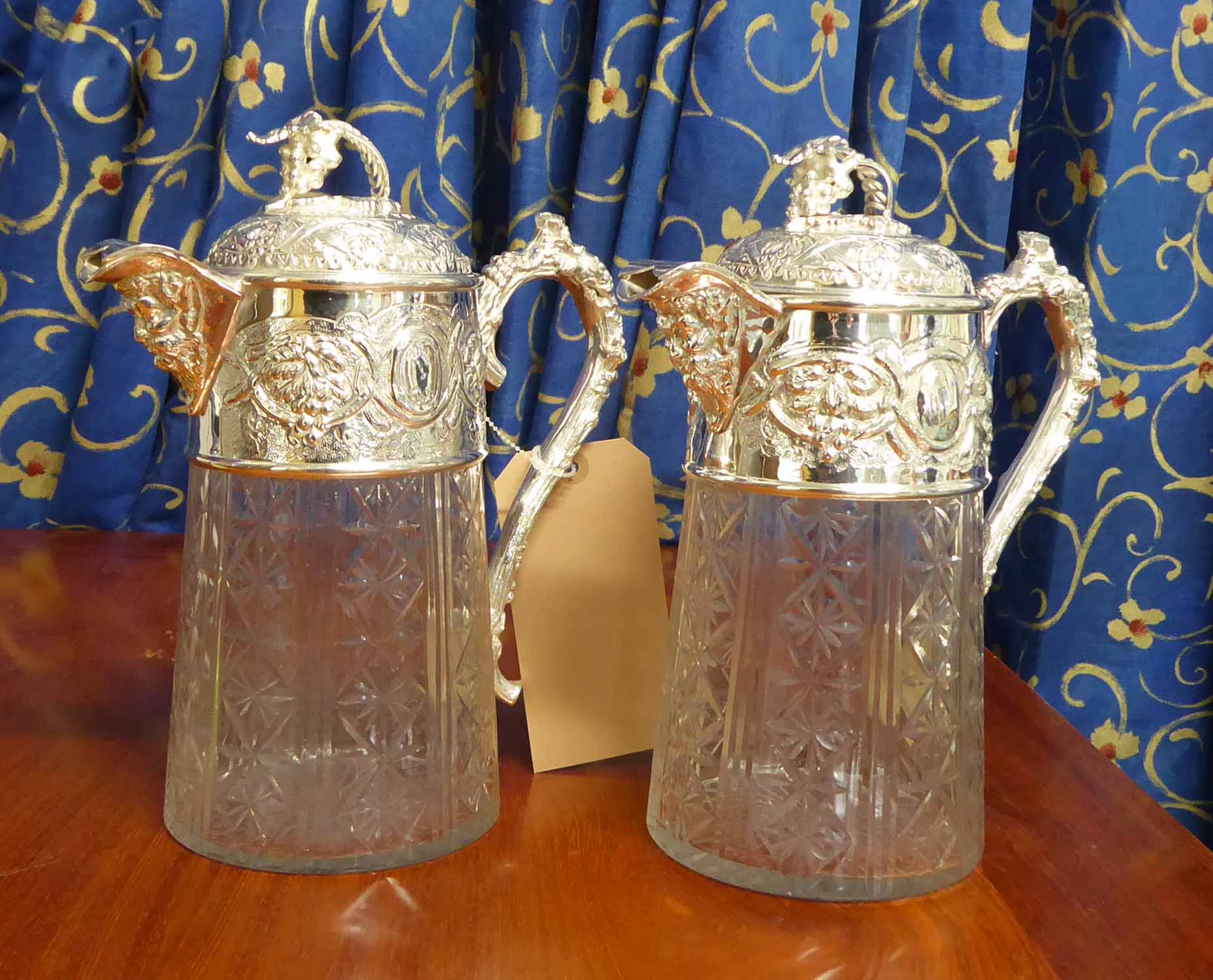 CLARET JUGS, a pair, 19th century style, with grape vine design, 28cm H.