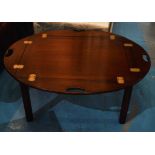 BUTLERS TRAY TABLE, Georgian style mahogany with oval hinged handled top,