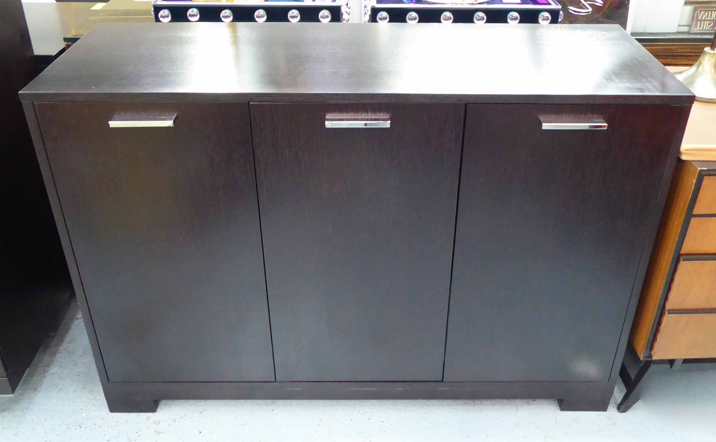 SIDE CABINET, ebonised finish with polished metal handles, 87cm H x 126cm W x 45cm D.