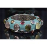 A STRIKING GEM SET ENAMEL BANGLE,