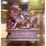 TEMPLE LIONS ON PLINTH, Asian, carved wood, approx 23cm H.