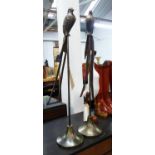 BIRDS ON STANDS, a pair, stylised bronzed finish, 83cm H.