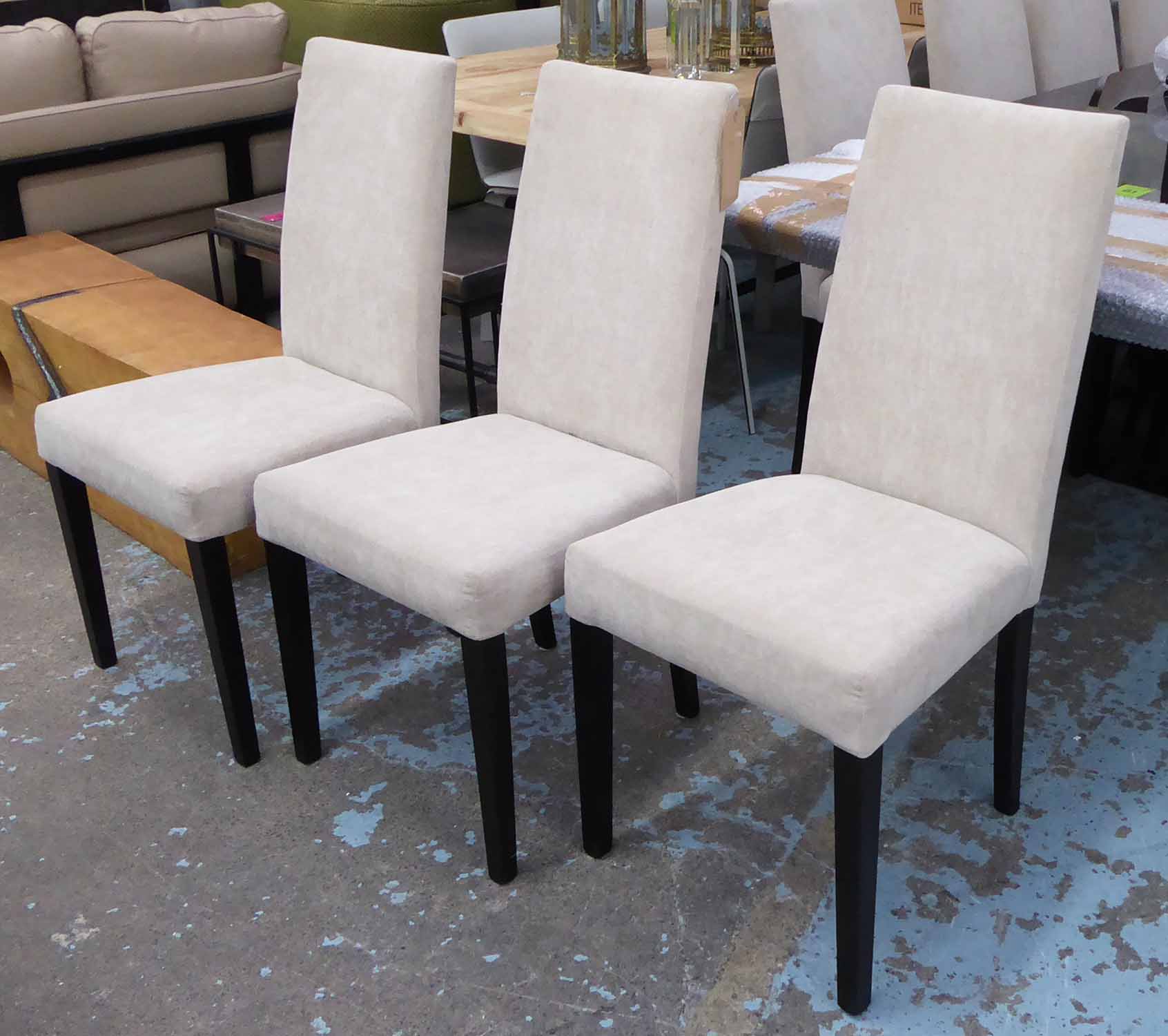 DINING CHAIRS, a set of twelve, ivory upholstery with square tapered supports, 96cm H x 47cm.