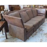 KNOLE SOFA, of substantial proportions, brown leather with studded detail and striped cushions,