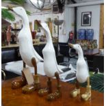 FAMILY OF DUCKS, three white coats with polished boots, 57cm tallest.