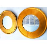 WALL MIRRORS, a pair, circular gilt each with broad gilt frame, 60cm diam.