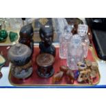 TRAY CONTAINING 3 VARIOUS DECANTERS, AFRICAN FIGURE ORNAMENTS, LIDDED BOX, SET OF WOODEN COASTERS,