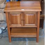 A MODERN TEAK DOUBLE DOOR CABINET