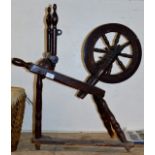 AN OLD WOODEN SPINNING WHEEL