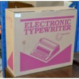 A VINTAGE ELECTRONIC TYPEWRITER IN BOX