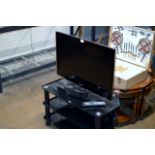 A SAMSUNG 32" HD READY LCD TV COMPLETE WITH REMOTE & STAND