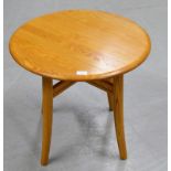 A 24" DIAMETER ERCOL LIGHT OAK OCCASIONAL TABLE