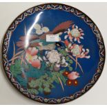 AN 11¾" DIAMETER ORIENTAL CLOISONNÉ WALL CHARGER DECORATED WITH A BIRD AMONGST FLOWERS