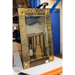 AN ARTS & CRAFTS STYLE BRASS FRAMED WALL MIRROR