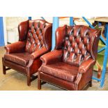 A PAIR OF CHESTERFIELD OX BLOOD LEATHER WING BACK ARM CHAIRS