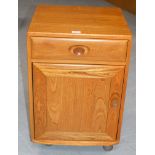 AN 18¼" ERCOL LIGHT OAK CABINET WITH SINGLE DRAWER