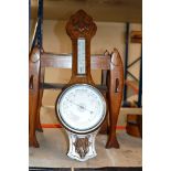 AN OAK CASED COMBINATION BAROMETER THERMOMETER