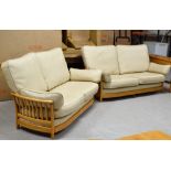 A 2 PIECE ERCOL CREAM LEATHER & LIGHT OAK FRAMED LOUNGE SUITE COMPRISING 2 X 2 SEATER SETTEES