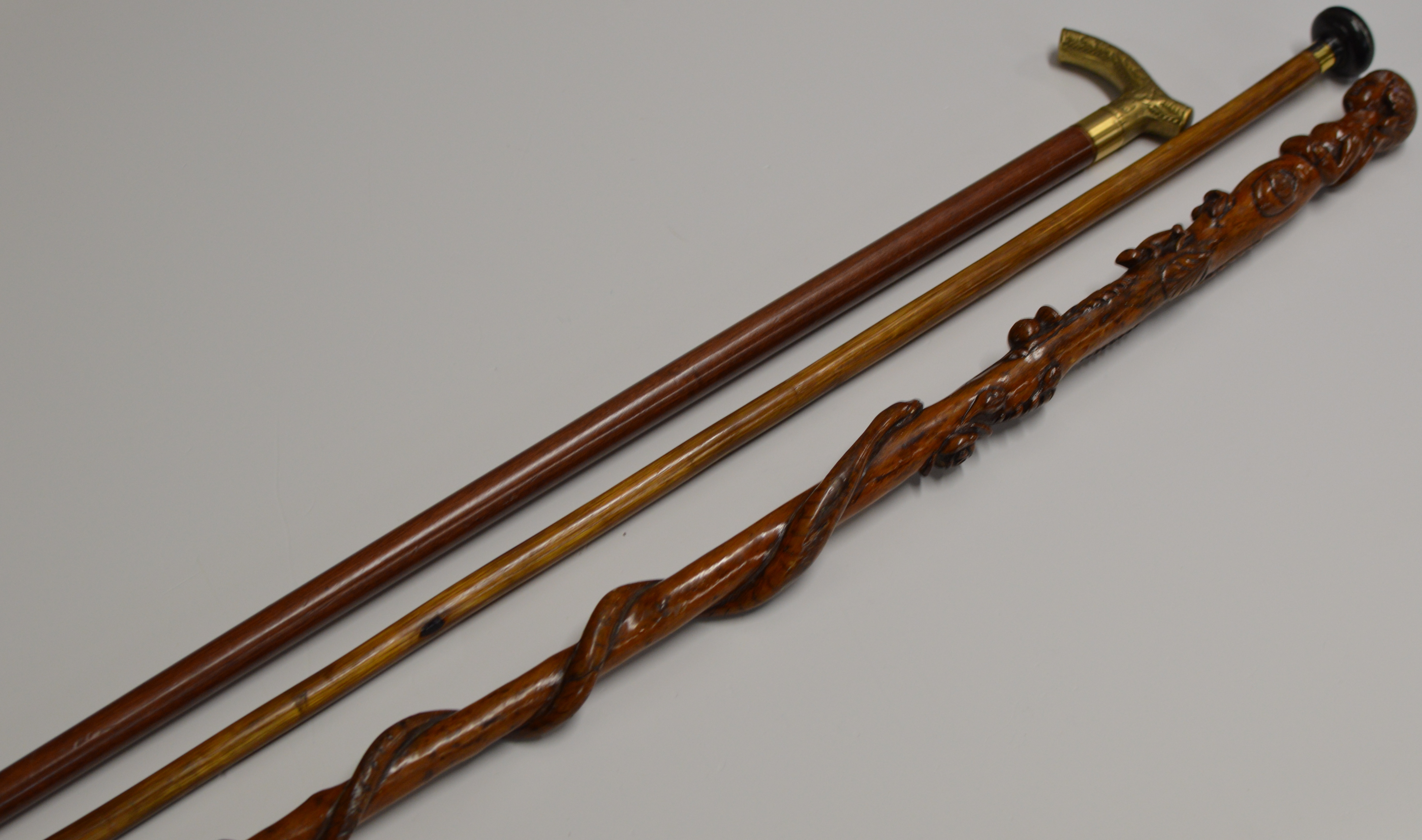 34½" OLD CARVED WOODEN WALKING STICK WITH THE HANDLE MODELLED AS A FEMALE FIGURE WITH OTHER