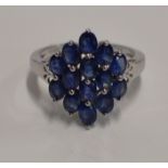 CONTEMPORARY 9 CARAT WHITE GOLD LADIES RING SET WITH 14 OVAL SHAPED CEYLON SAPPHIRES