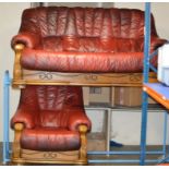 2 PIECE WINE LEATHER LOUNGE SUITE WITH WOODEN FRAME COMPRISING 3 SEATER SETTEE & SINGLE ARM CHAIR