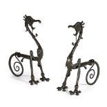 GOTHIC REVIVALPAIR OF IMPRESSIVE WROUGHT STEEL FIRE DOGS, CIRCA 1880 each worked as fearsome