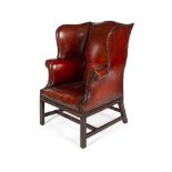 GEORGIAN STYLE RED LEATHER WING ARMCHAIR20TH CENTURY the serpentine back with deep wings and