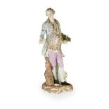 LARGE MEISSEN FIGURE OF A GENTLEMANLATE 19TH CENTURY with a floral jacket and gilded waistcoat above