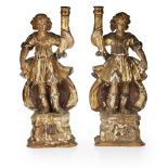 PAIR OF ITALIAN GILTWOOD AND POLYCHROME FIGURAL CANDLESTICKS18TH CENTURY carved as Roman men holding