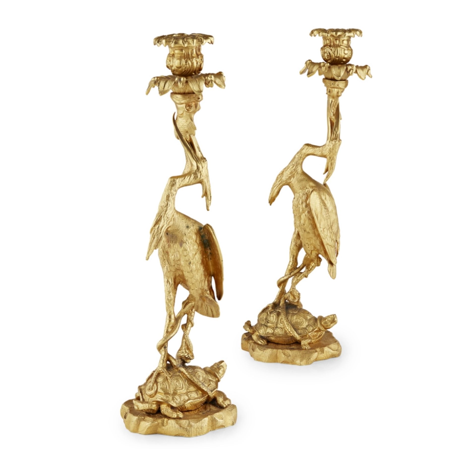 PAIR OF GEORGE IV GILT BRONZE HERON CANDLESTICKSCIRCA 1830 with everted foliate and rocaille