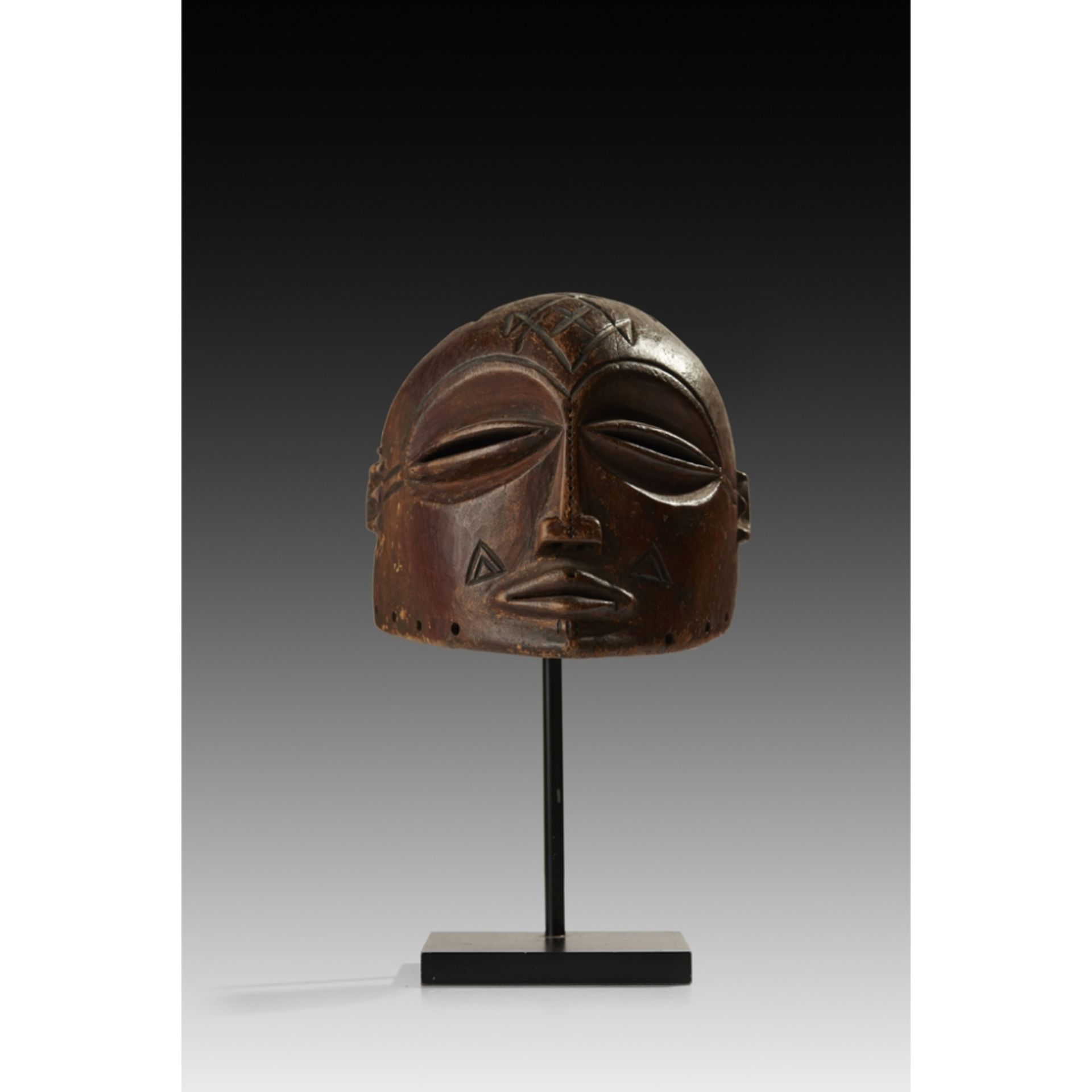 LUVALE MASKZAMBIA carved wood, coffee-bean eyes, slender nose and sensitively rendered lips,