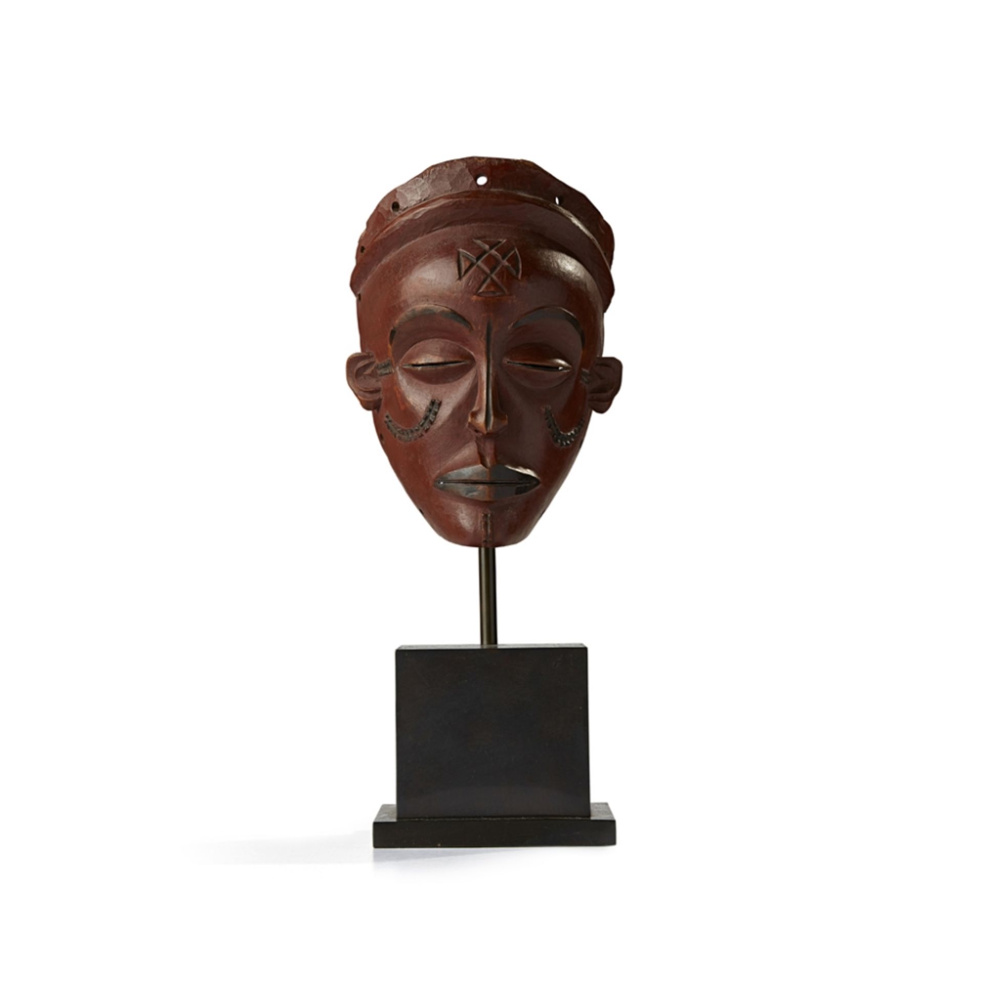 CHOKWE MASK, PWOANGOLA carved wood, the softly curving chin below fractionally parted lips, a medial