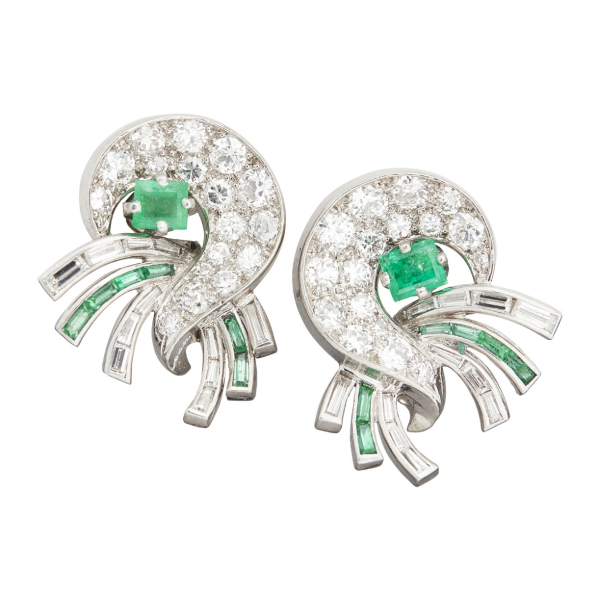 A pair of 1940s emerald and diamond set ear-clipseach of stylised scrolling design, pavé set with