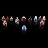COLLECTION OF TWELVE SNUFF BOTTLES19TH/20TH CENTURY comprising: a red-overlay clear glass bottle,