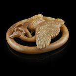 RUSSET JADE 'BIRDS' PLAQUEthe oval plaque superbly carved and undercut with a wild goose in