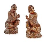 PAIR OF WOODEN FIGURES OF LUOHANLATE QING DYNASTY supported on a lotus plinth, each bearded figure
