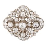 A 19th century diamond set brooch claw set with a cushion cut diamond, in a stylised surround of