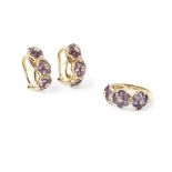 A suite of amethyst jewellery comprising a ring and a pair of earrings, each composed of three